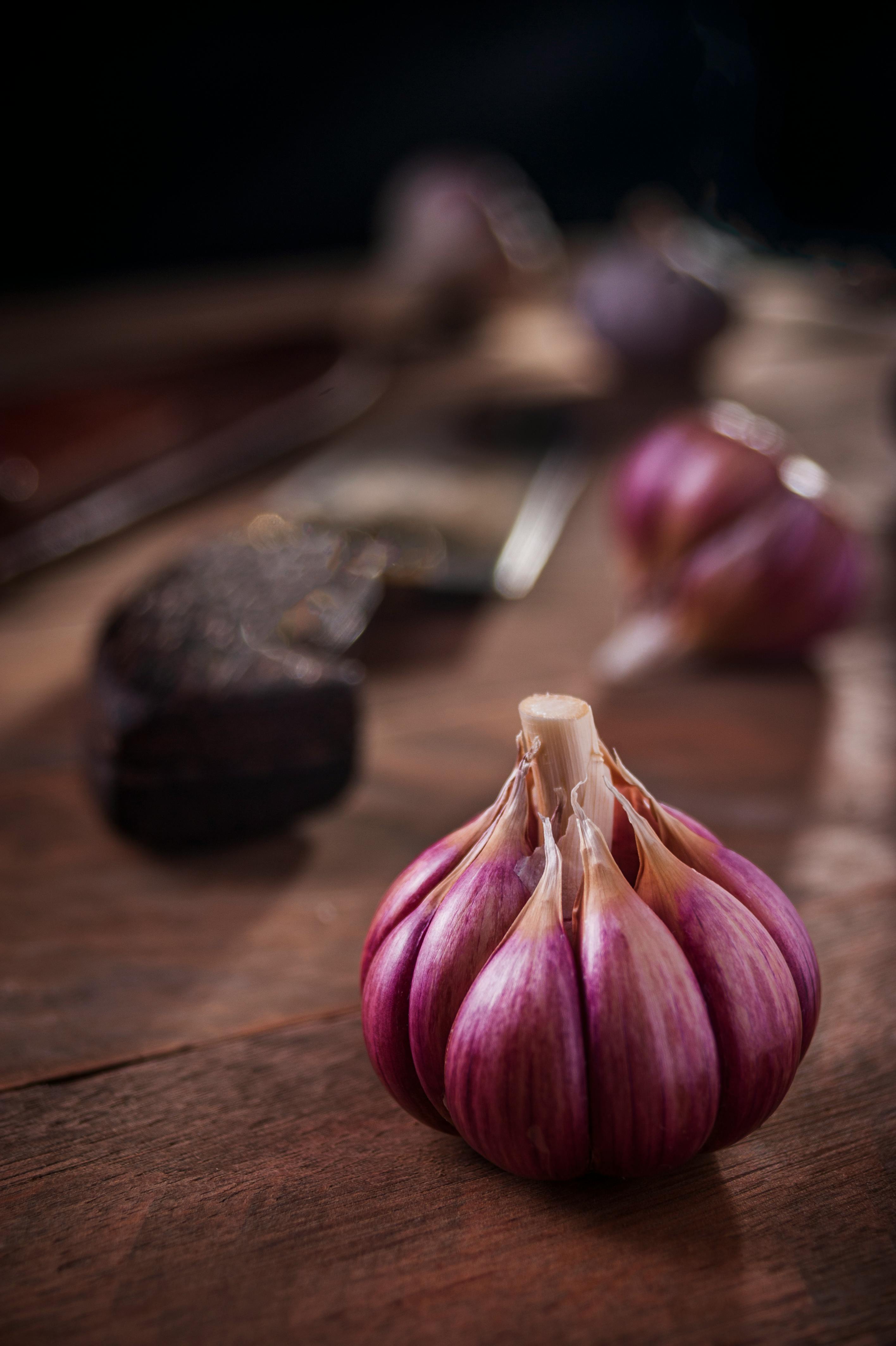 Purple garlic on wood